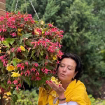 Carboxy Hands treatment 2 ruta posing near the flowers